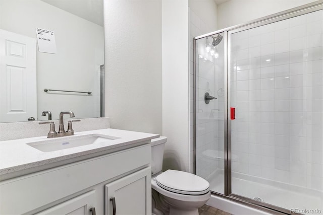 bathroom with vanity, toilet, and an enclosed shower