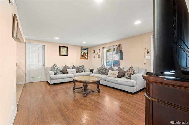 living room with light wood-style flooring and recessed lighting