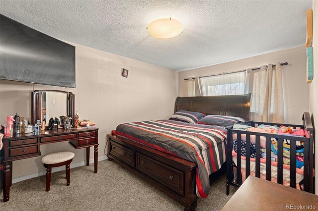 carpeted bedroom with a textured ceiling and baseboards