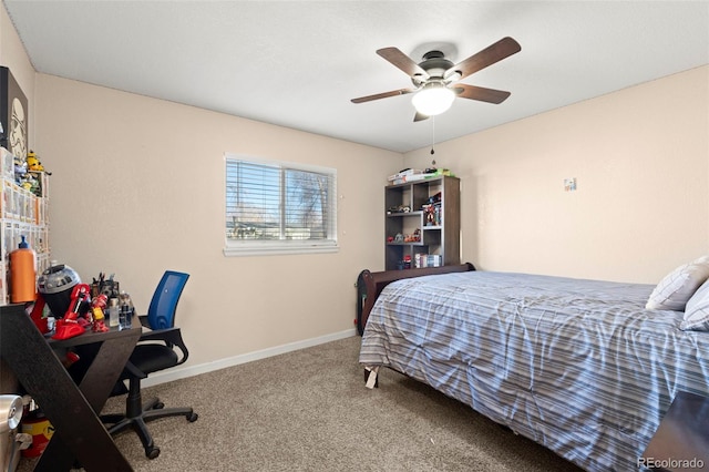 carpeted bedroom with ceiling fan and baseboards