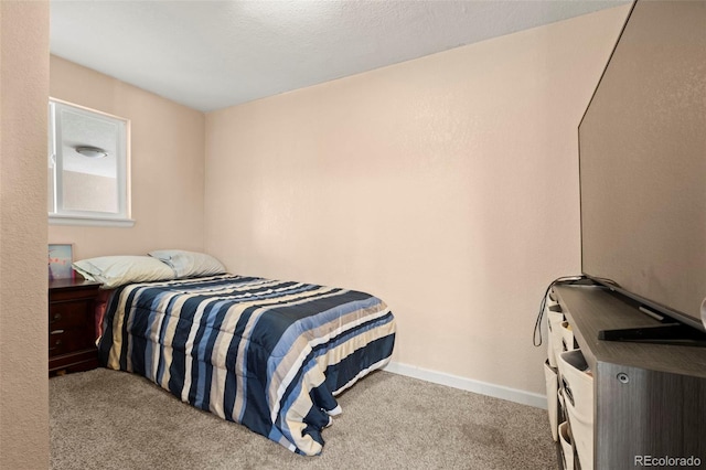 bedroom with carpet floors and baseboards