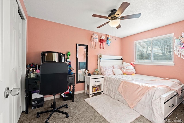 carpeted bedroom featuring a ceiling fan, a textured ceiling, baseboards, and a closet