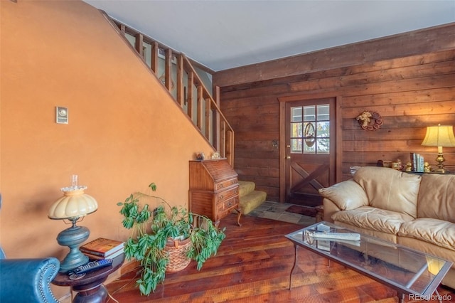 living room featuring wooden walls and dark hardwood / wood-style floors