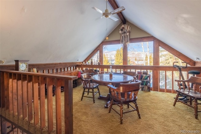 dining space with carpet flooring, lofted ceiling with beams, and ceiling fan