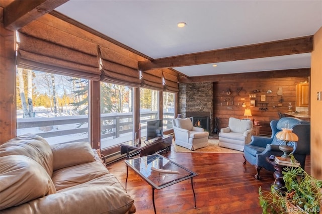 sunroom / solarium featuring beam ceiling and a fireplace