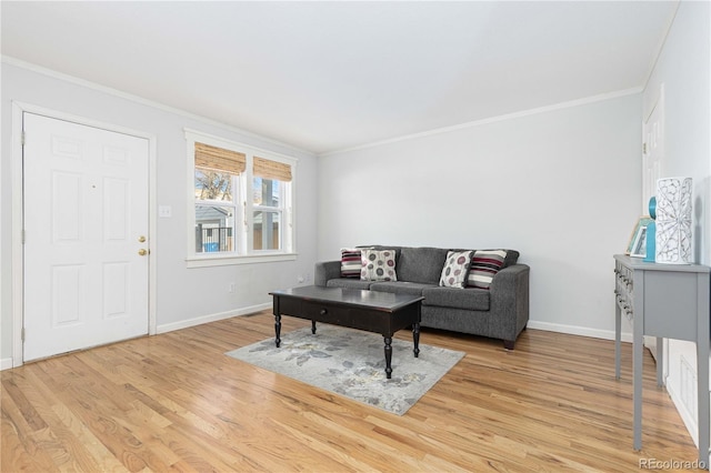 living room with light wood-type flooring and crown molding