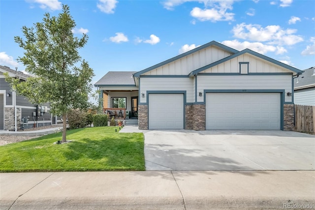 view of front of property with a porch, a garage, and a front yard