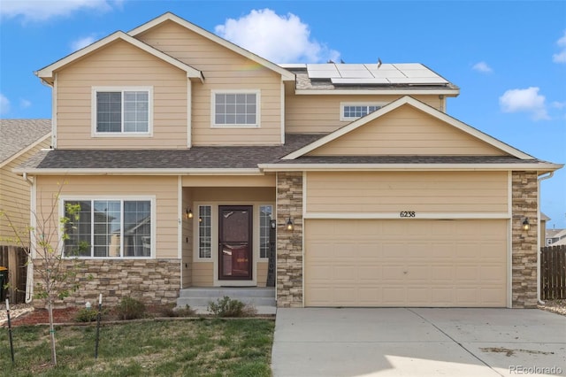 view of front of property with solar panels and a garage