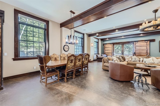 dining area featuring a chandelier, baseboards, finished concrete flooring, and healthy amount of natural light