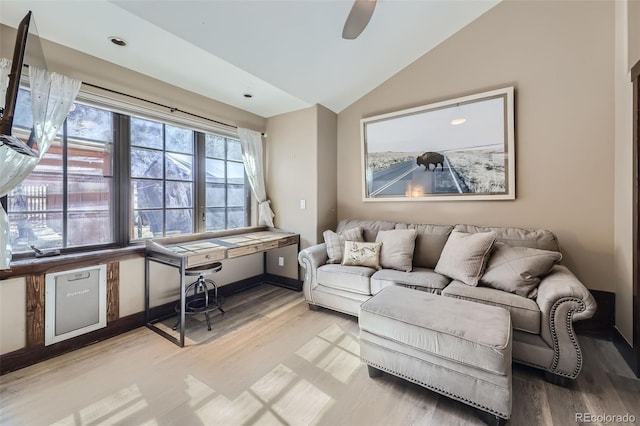 living room with vaulted ceiling, light wood-style floors, a ceiling fan, and a desk