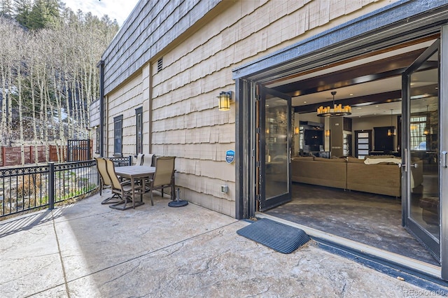 view of patio with fence and outdoor dining space