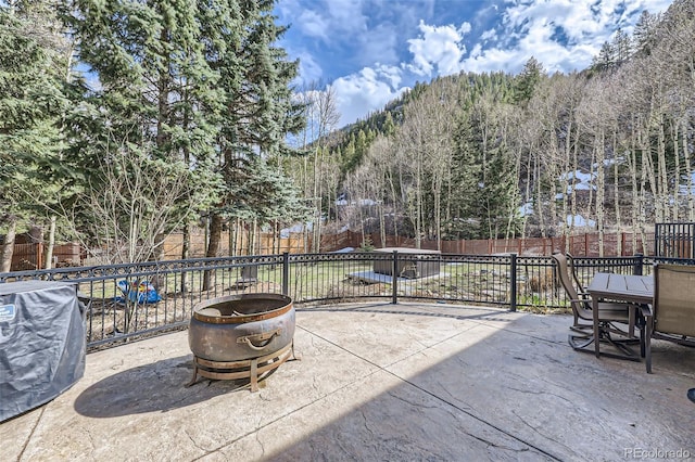 view of patio / terrace with a mountain view and a fenced backyard
