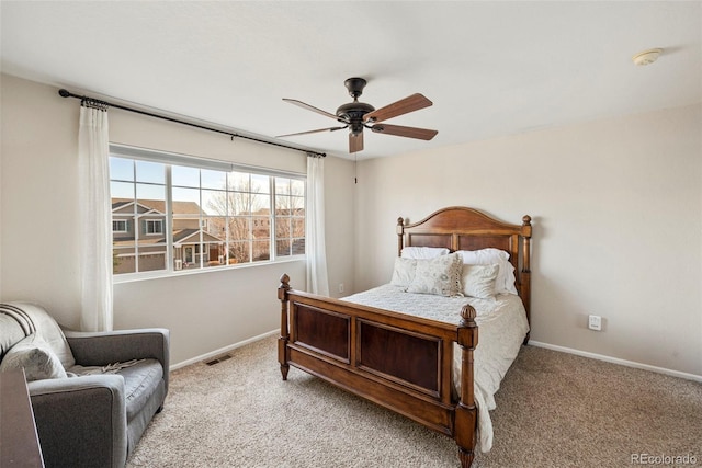 bedroom with light carpet, a ceiling fan, visible vents, and baseboards