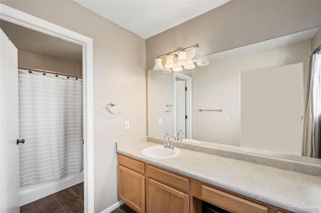 bathroom with wood finished floors and vanity