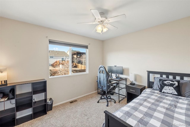 carpeted bedroom with a ceiling fan, visible vents, and baseboards