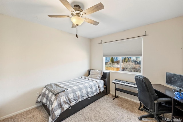 bedroom featuring light colored carpet, ceiling fan, and baseboards