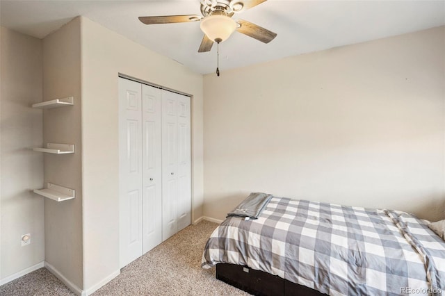 bedroom featuring a closet, light colored carpet, and baseboards