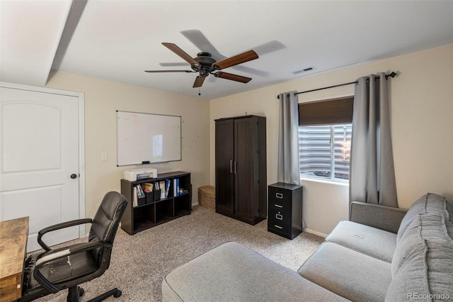 office with light carpet, baseboards, visible vents, and a ceiling fan