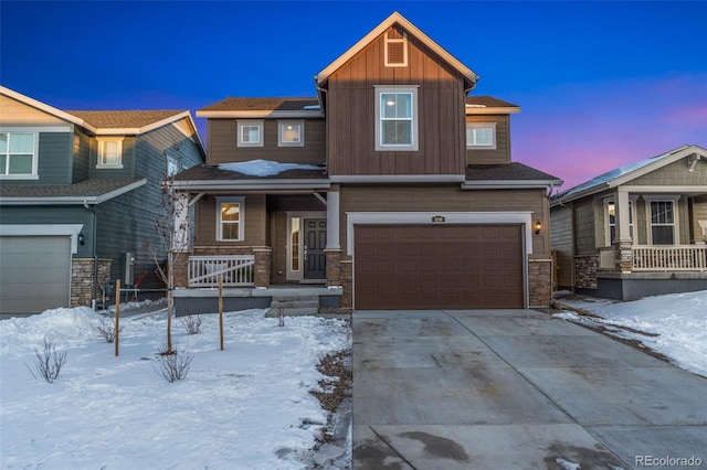 craftsman-style house with driveway, stone siding, an attached garage, a porch, and board and batten siding