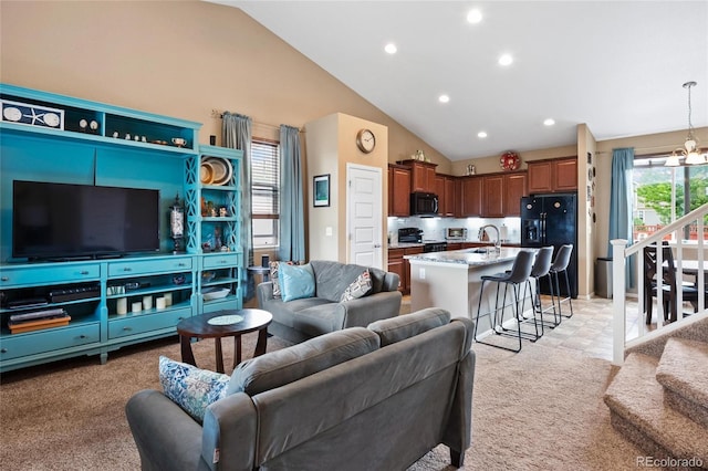 carpeted living room with vaulted ceiling, sink, and a chandelier