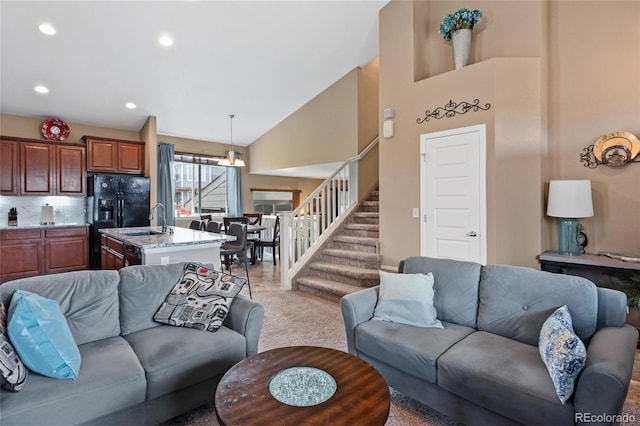 carpeted living room with lofted ceiling and sink