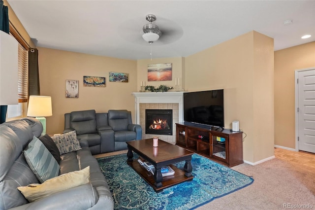 carpeted living room with a tile fireplace