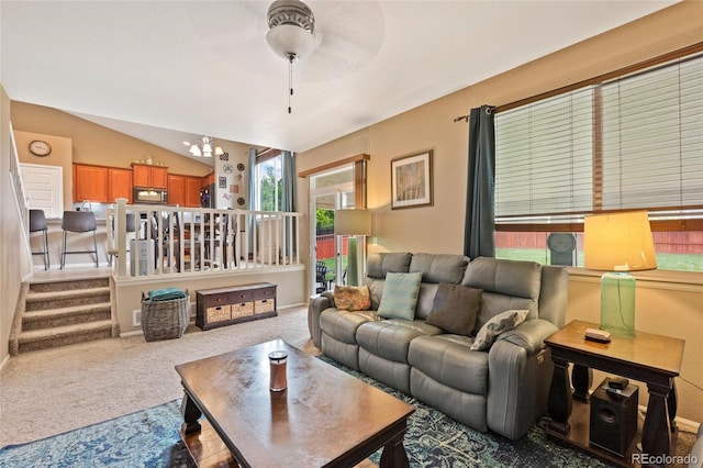 living room with vaulted ceiling, carpet floors, and a notable chandelier