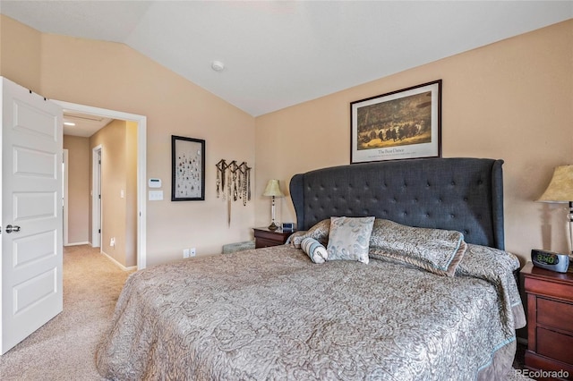 bedroom with vaulted ceiling and light carpet