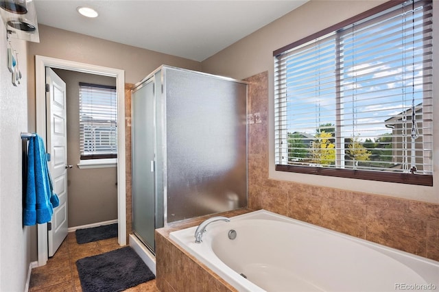 bathroom with tile patterned flooring, plus walk in shower, and a healthy amount of sunlight