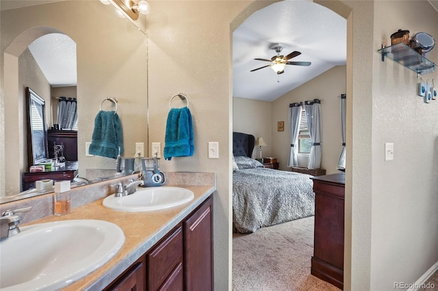 bathroom featuring lofted ceiling, vanity, and ceiling fan