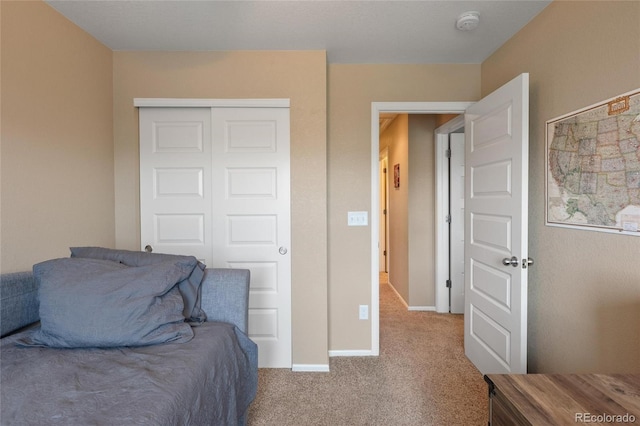 bedroom with light colored carpet and a closet