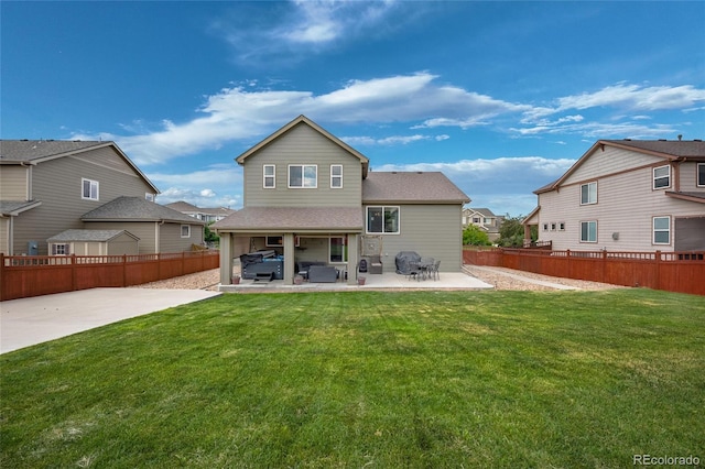 rear view of property featuring a yard and a patio