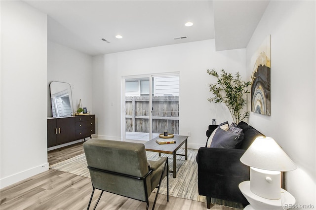 sitting room with visible vents, baseboards, and light wood-style floors