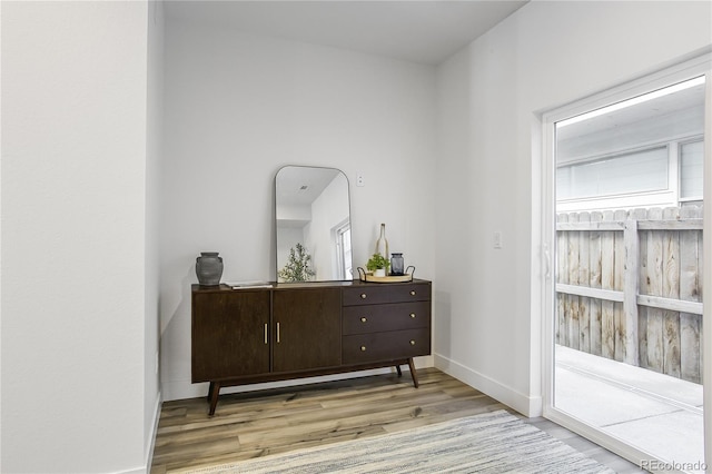 interior space featuring baseboards and wood finished floors