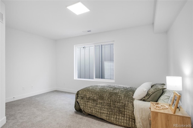 carpeted bedroom with visible vents and baseboards