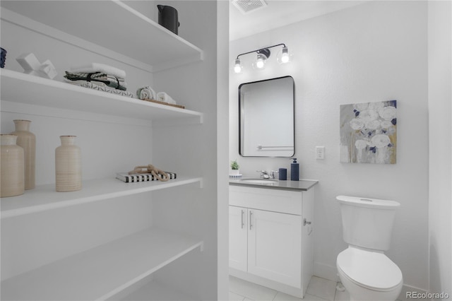 bathroom featuring vanity, toilet, baseboards, and visible vents