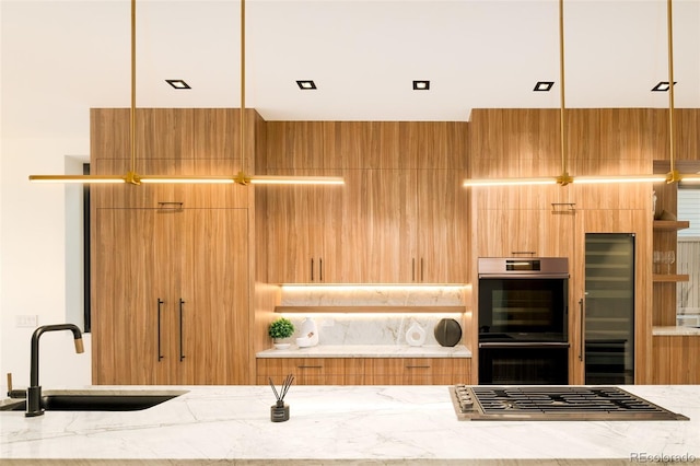 kitchen with light stone countertops, sink, and stainless steel appliances