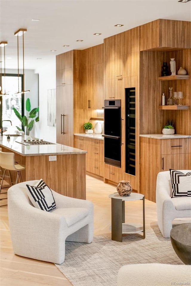 living room with light hardwood / wood-style flooring and wooden walls