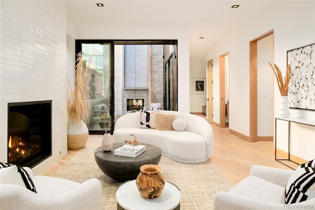 living room featuring light hardwood / wood-style floors and a fireplace