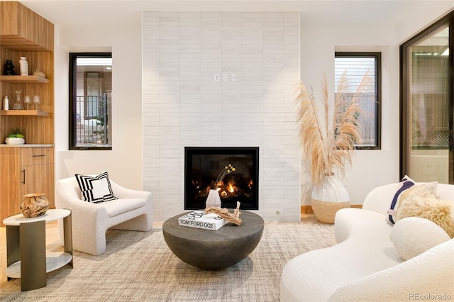 living area with a tiled fireplace