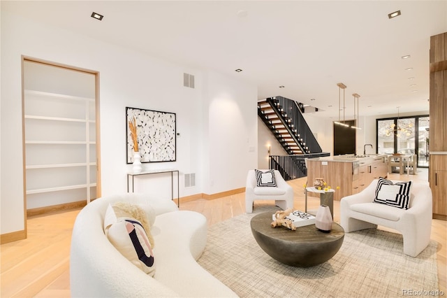 living room with sink and light wood-type flooring