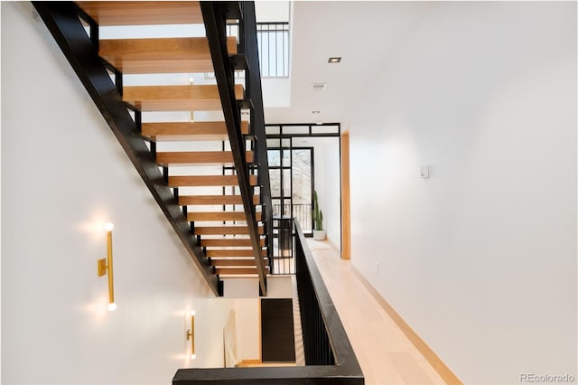 stairway with hardwood / wood-style flooring