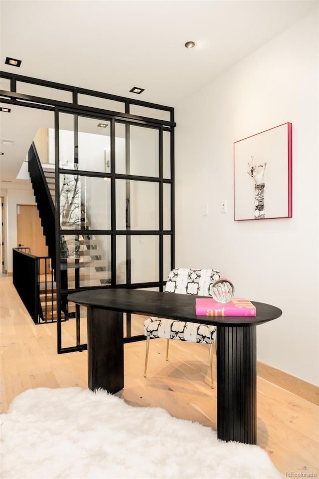 home office with wood-type flooring