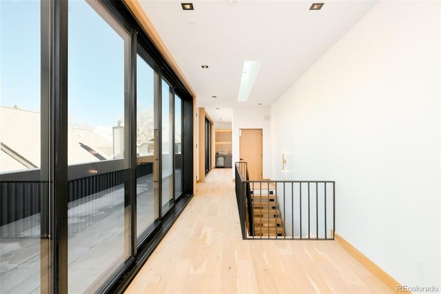 hallway with light hardwood / wood-style flooring