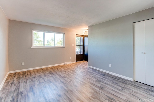 unfurnished room with light hardwood / wood-style floors