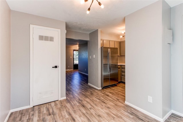 spare room featuring light hardwood / wood-style flooring