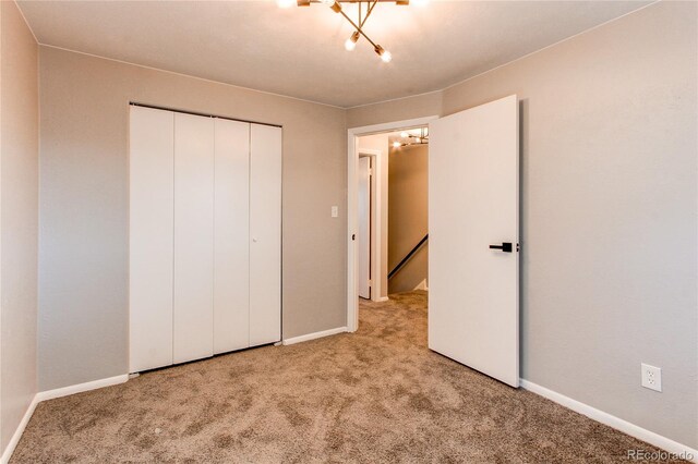 unfurnished bedroom with light carpet and a closet