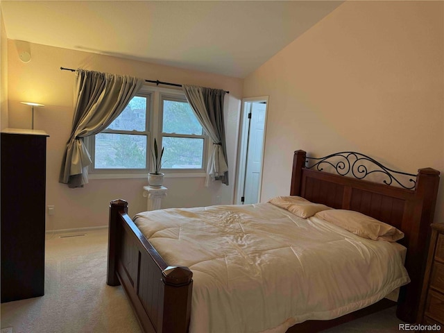 carpeted bedroom featuring lofted ceiling