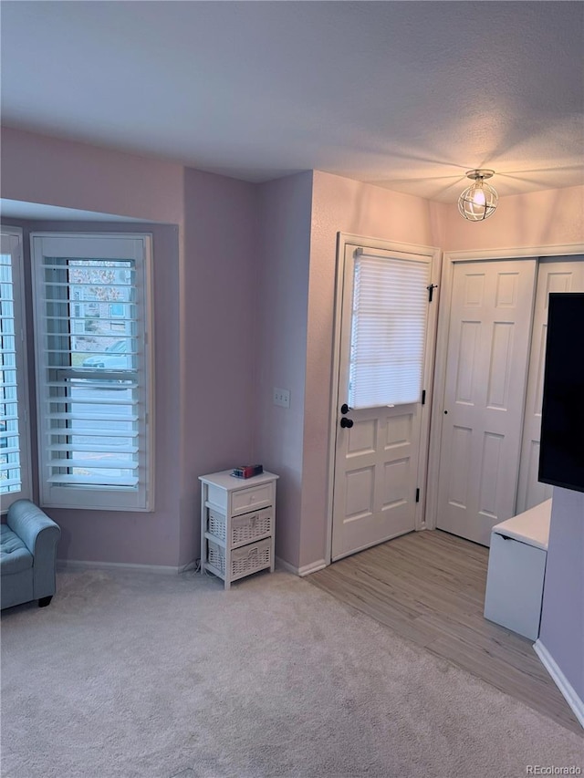 entrance foyer with light carpet