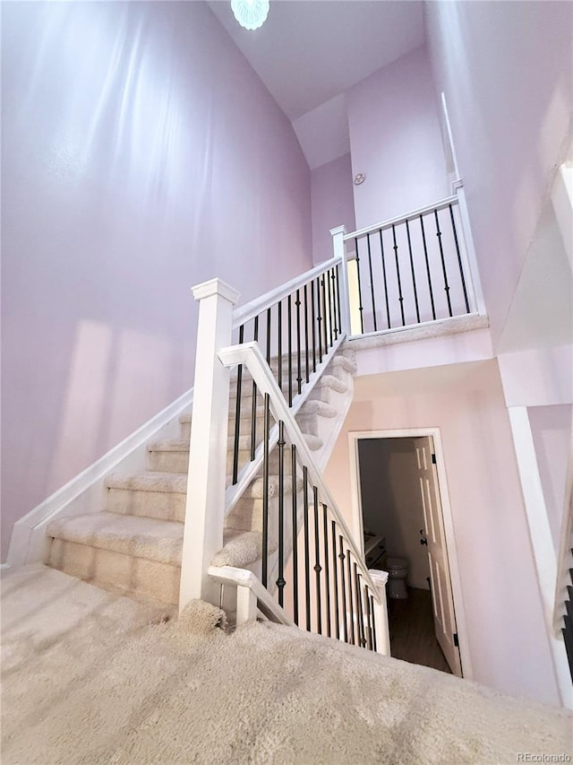 stairs featuring a towering ceiling